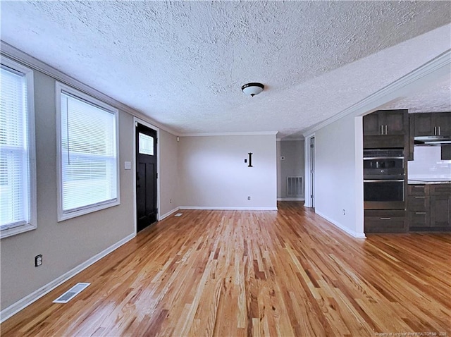 7246 Faircloth Bridge Rd, Stedman, NC 28391 - unfurnished living room featuring light wood-type flooring, a textured ceiling, and ornamental molding