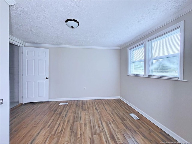 7246 Faircloth Bridge Rd, Stedman, NC 28391 - empty room featuring wood finished floors, a textured ceiling, and crown molding