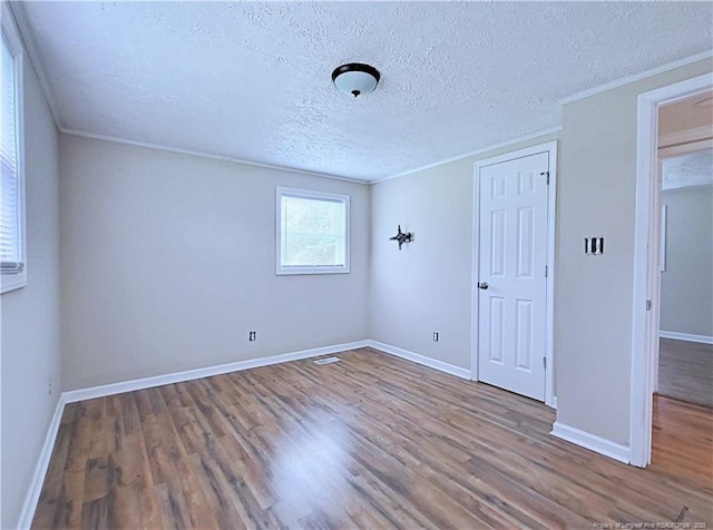 7246 Faircloth Bridge Rd, Stedman, NC 28391 - unfurnished room with wood finished floors, a textured ceiling, and crown molding