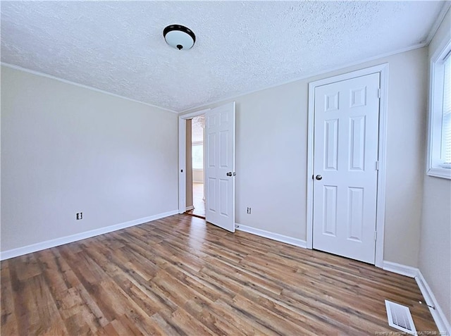 7246 Faircloth Bridge Rd, Stedman, NC 28391 - unfurnished bedroom featuring wood finished floors and a textured ceiling