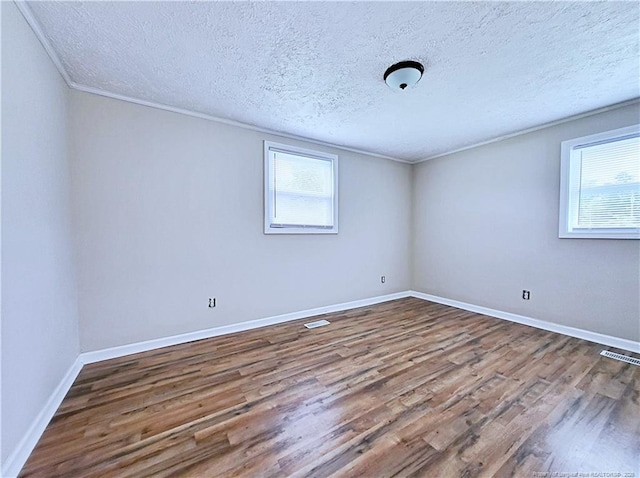 7246 Faircloth Bridge Rd, Stedman, NC 28391 - unfurnished room featuring wood finished floors, a textured ceiling, and ornamental molding