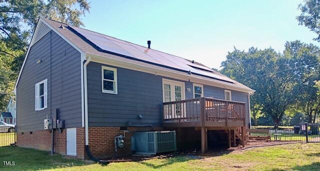 105 Meadow Brook Ln, Oxford, NC 27565 - back of property featuring roof mounted solar panels, a wooden deck, and brick siding