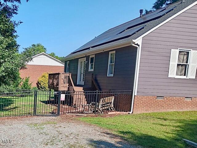 105 Meadow Brook Ln, Oxford, NC 27565 - view of home's exterior with crawl space and roof mounted solar panels