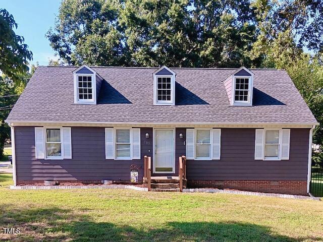 105 Meadow Brook Ln, Oxford, NC 27565 - new england style home with a front yard, entry steps, and a shingled roof