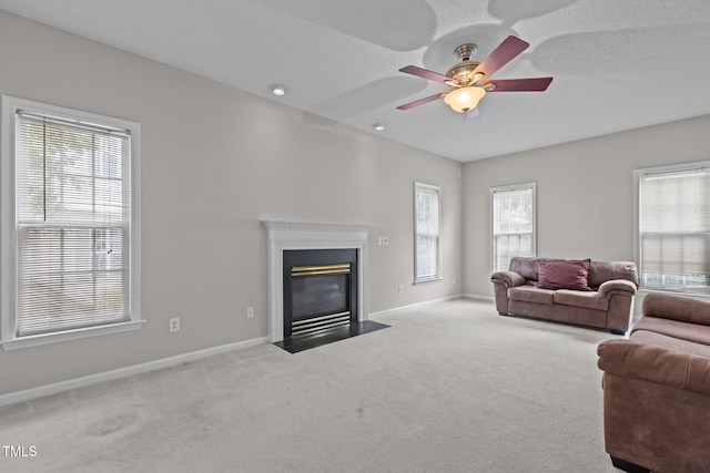 108 Tarlow Ct, Cary, NC 27513 - carpeted living area with ceiling fan, a fireplace with flush hearth, and a textured ceiling