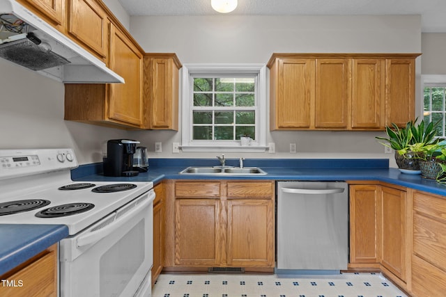 108 Tarlow Ct, Cary, NC 27513 - kitchen featuring electric range, dishwasher, under cabinet range hood, light floors, and dark countertops