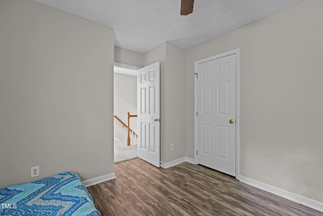 108 Tarlow Ct, Cary, NC 27513 - unfurnished bedroom featuring wood finished floors and a ceiling fan