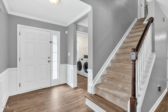 2127 Rivergrass Ct, Raleigh, NC 27610 - foyer entrance with independent washer and dryer, wood finished floors, stairs, ornamental molding, and wainscoting