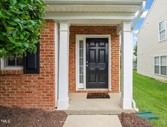 2127 Rivergrass Ct, Raleigh, NC 27610 - doorway to property featuring brick siding and a yard