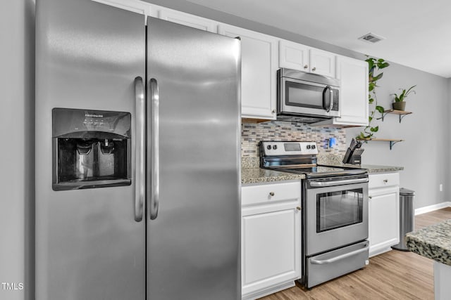 2127 Rivergrass Ct, Raleigh, NC 27610 - kitchen featuring stainless steel appliances, open shelves, white cabinetry, light wood finished floors, and tasteful backsplash