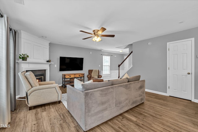 2127 Rivergrass Ct, Raleigh, NC 27610 - living area with a fireplace, ceiling fan, stairs, and wood finished floors