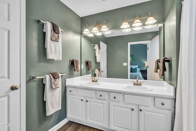 2127 Rivergrass Ct, Raleigh, NC 27610 - full bath featuring connected bathroom, double vanity, and wood finished floors