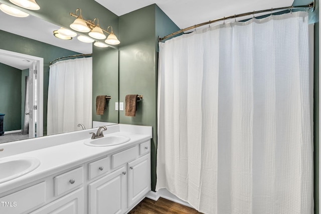 2127 Rivergrass Ct, Raleigh, NC 27610 - bathroom with double vanity, a shower with curtain, and wood finished floors