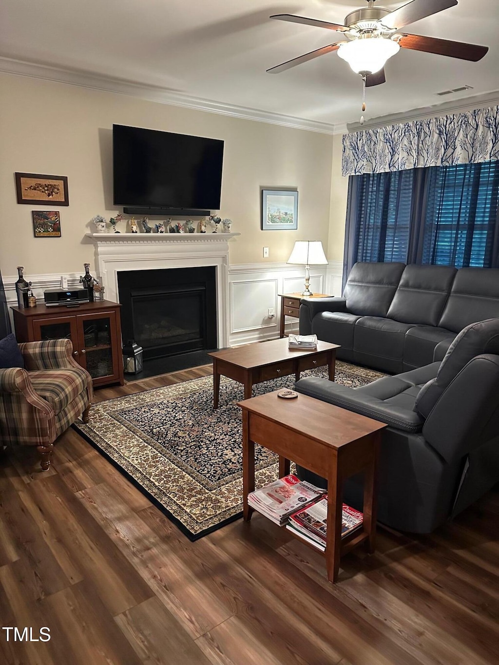 6004 Stony Falls Way, Knightdale, NC 27545 - living area with ornamental molding, ceiling fan, wood finished floors, a fireplace with flush hearth, and wainscoting