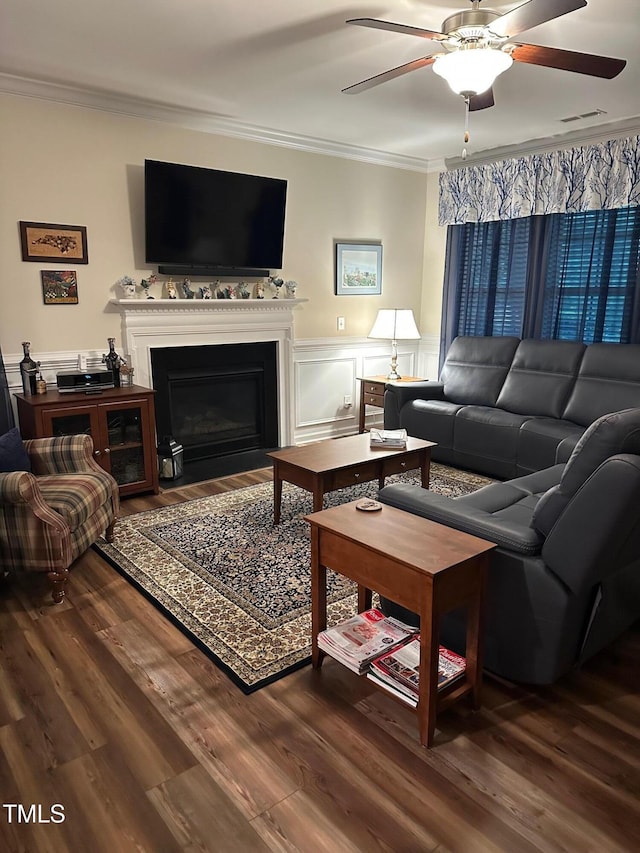 6004 Stony Falls Way, Knightdale, NC 27545 - living area with ornamental molding, ceiling fan, wood finished floors, a fireplace with flush hearth, and wainscoting