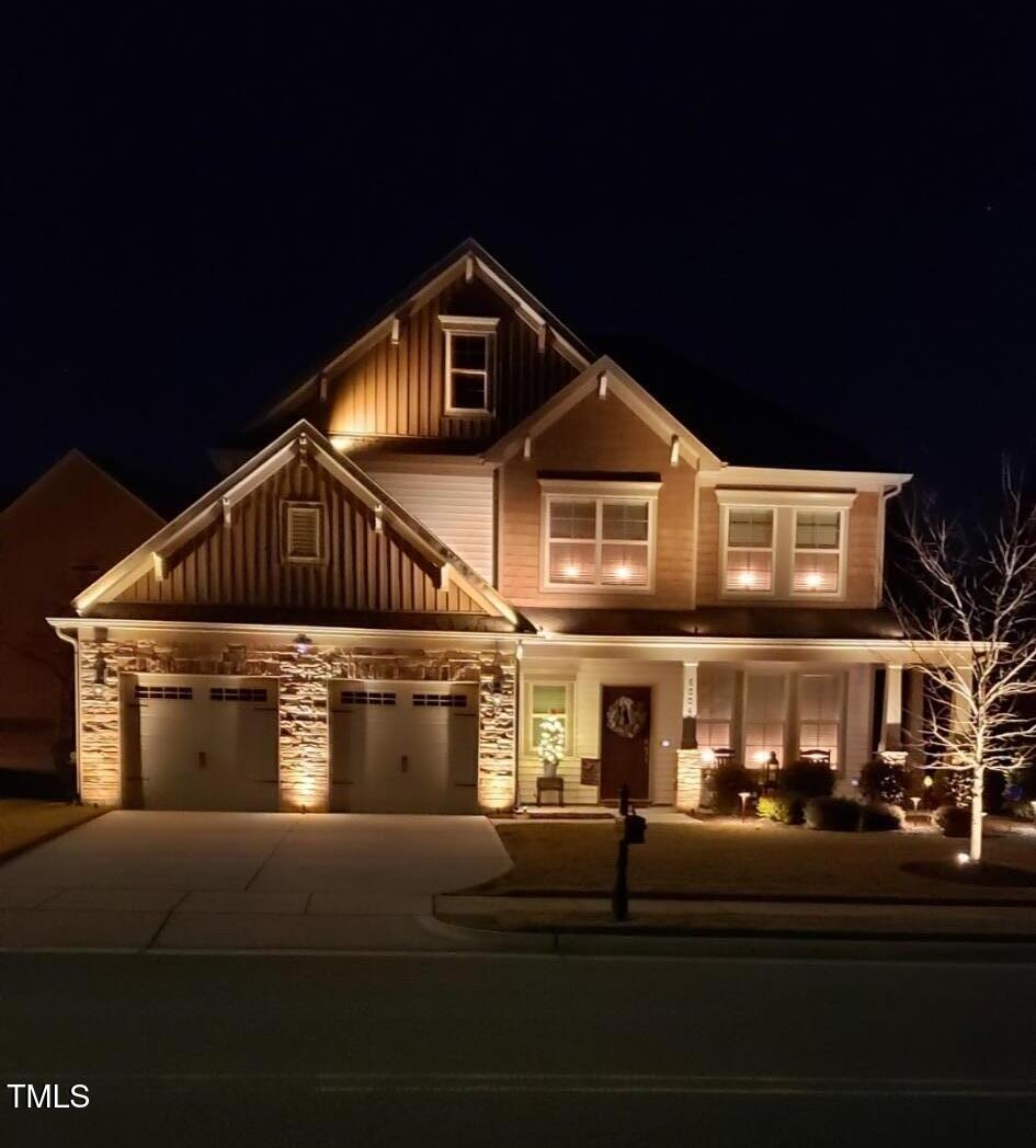 6004 Stony Falls Way, Knightdale, NC 27545 - craftsman inspired home featuring board and batten siding, stone siding, driveway, a garage, and a porch