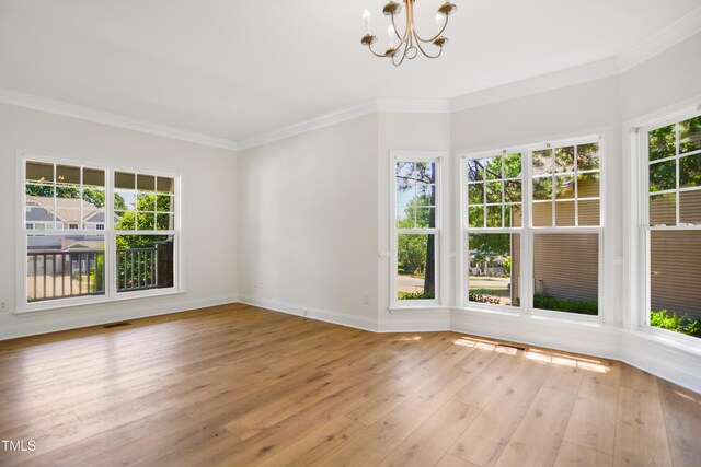 80 Clubhouse Dr, Youngsville, NC 27596 - empty room featuring a chandelier, crown molding, and light wood-style flooring