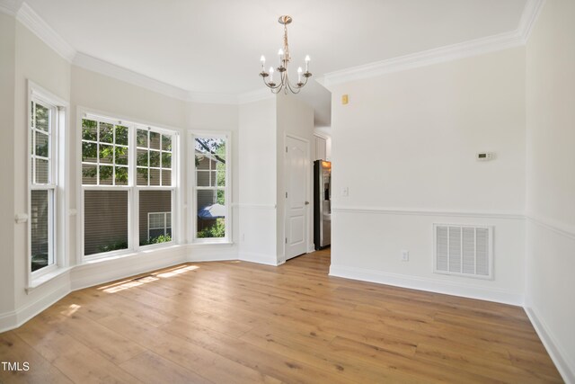 80 Clubhouse Dr, Youngsville, NC 27596 - unfurnished room featuring a chandelier, crown molding, and light wood-type flooring