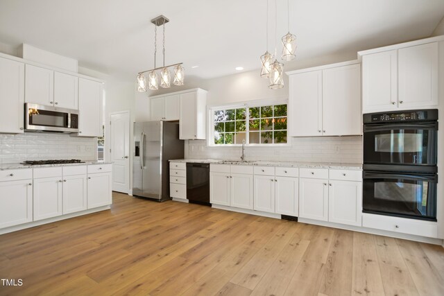 80 Clubhouse Dr, Youngsville, NC 27596 - kitchen with black appliances, a chandelier, tasteful backsplash, white cabinets, and hanging light fixtures