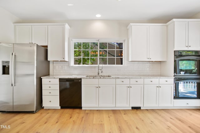 80 Clubhouse Dr, Youngsville, NC 27596 - kitchen with black appliances, white cabinets, light stone counters, decorative backsplash, and recessed lighting