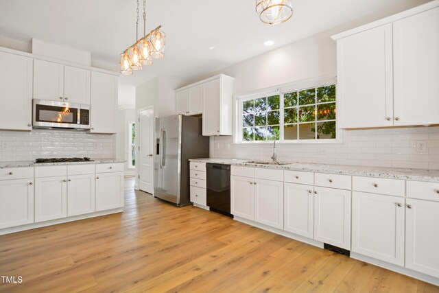 80 Clubhouse Dr, Youngsville, NC 27596 - kitchen featuring stainless steel appliances, backsplash, white cabinetry, light wood-style floors, and recessed lighting