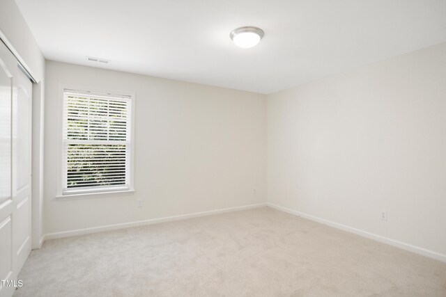 80 Clubhouse Dr, Youngsville, NC 27596 - unfurnished bedroom with a closet and light colored carpet