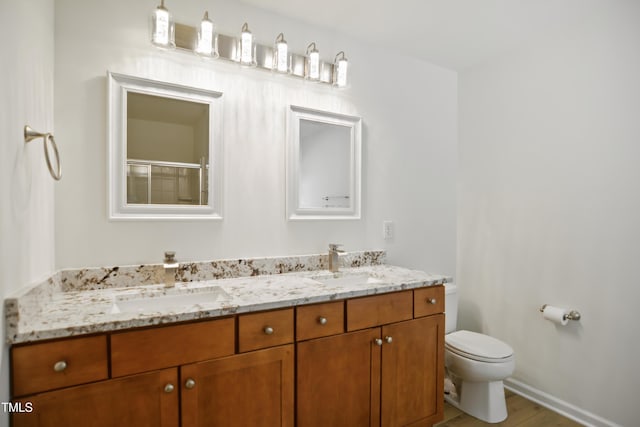 80 Clubhouse Dr, Youngsville, NC 27596 - full bathroom featuring double vanity, an enclosed shower, and wood finished floors