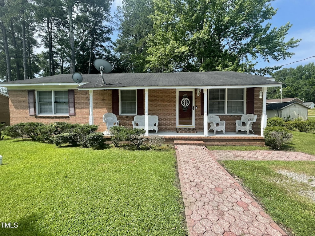 503 Indian Trl, Nashville, NC 27856 - ranch-style house with a porch, brick siding, and a front yard