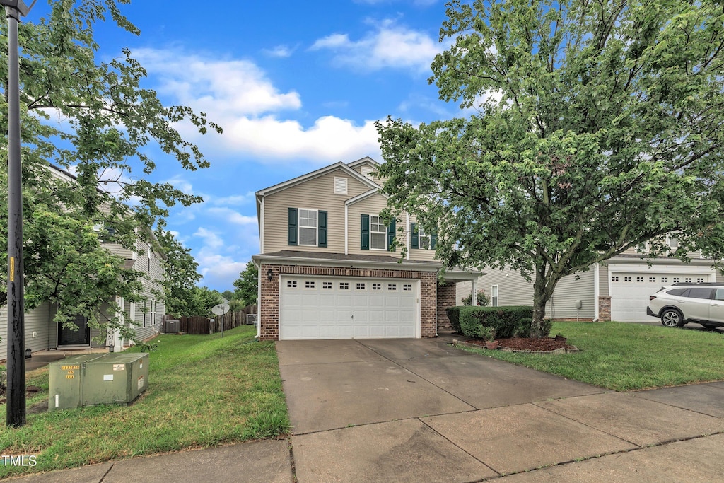 1405 Kingman Dr, Knightdale, NC 27545 - traditional home with brick siding, concrete driveway, and a garage
