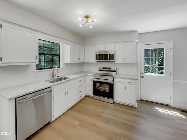 11 Sweetbay Ct, Durham, NC 27704 - kitchen featuring appliances with stainless steel finishes, plenty of natural light, and white cabinetry