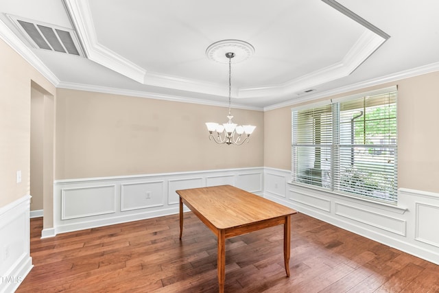 428 Holsten Bank Way, Cary, NC 27519 - dining room featuring a tray ceiling, wood finished floors, ornamental molding, a chandelier, and wainscoting