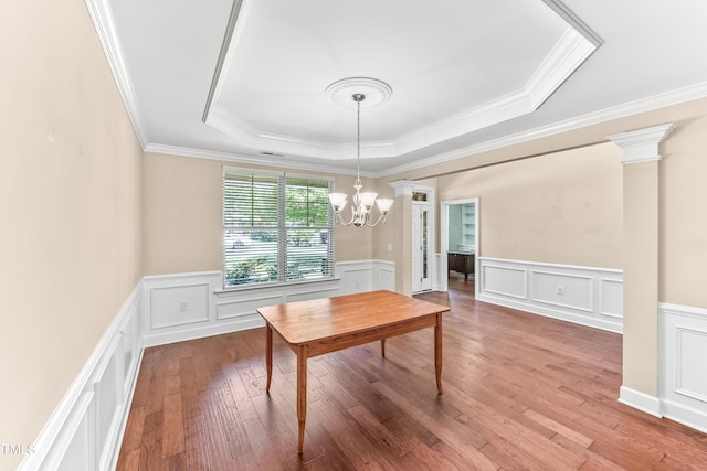 428 Holsten Bank Way, Cary, NC 27519 - dining area with a raised ceiling, a decorative wall, a chandelier, ornamental molding, and wood finished floors