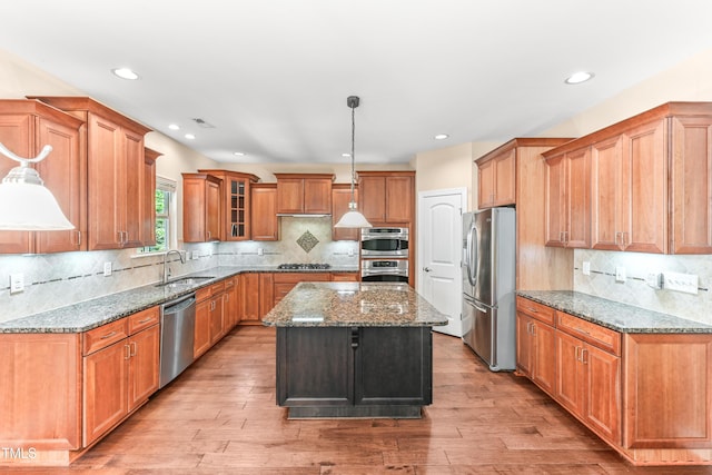 428 Holsten Bank Way, Cary, NC 27519 - kitchen with stainless steel appliances, a center island, dark stone countertops, and recessed lighting