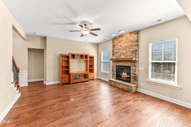 428 Holsten Bank Way, Cary, NC 27519 - unfurnished living room with ceiling fan, a fireplace, hardwood / wood-style flooring, and plenty of natural light