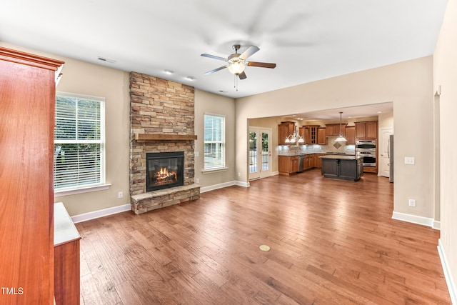 428 Holsten Bank Way, Cary, NC 27519 - living room with ceiling fan, light wood finished floors, and a stone fireplace