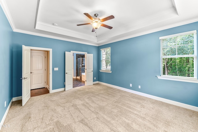 428 Holsten Bank Way, Cary, NC 27519 - unfurnished bedroom with a tray ceiling, carpet, crown molding, and a ceiling fan