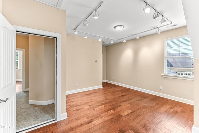 428 Holsten Bank Way, Cary, NC 27519 - spare room featuring rail lighting and wood finished floors
