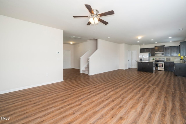 2522 Dalmahoy Ln, Fuquay Varina, NC 27526 - living room featuring wood finished floors, stairs, ceiling fan, and recessed lighting