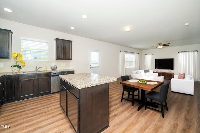 2522 Dalmahoy Ln, Fuquay Varina, NC 27526 - kitchen featuring dishwasher, light wood finished floors, a kitchen island, dark brown cabinetry, and a ceiling fan
