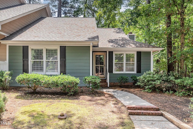 1520 Woodcroft Dr, Raleigh, NC 27609 - view of front of house with roof with shingles and a chimney