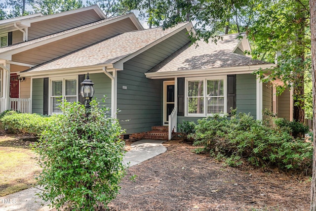 1520 Woodcroft Dr, Raleigh, NC 27609 - view of front of home featuring roof with shingles, entry steps, and crawl space