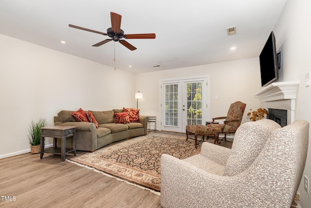 1520 Woodcroft Dr, Raleigh, NC 27609 - living room with light wood-style flooring, a fireplace, a ceiling fan, and recessed lighting
