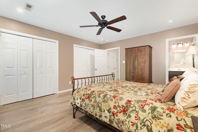 1520 Woodcroft Dr, Raleigh, NC 27609 - bedroom with multiple closets, light wood-type flooring, ceiling fan, ensuite bath, and recessed lighting