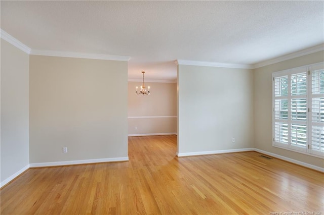 2630 Dartmouth Dr, Fayetteville, NC 28304 - spare room with a chandelier, light wood-type flooring, ornamental molding, and a textured ceiling