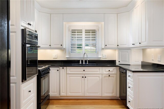 2630 Dartmouth Dr, Fayetteville, NC 28304 - kitchen featuring black appliances, white cabinetry, dark countertops, and light wood-style floors