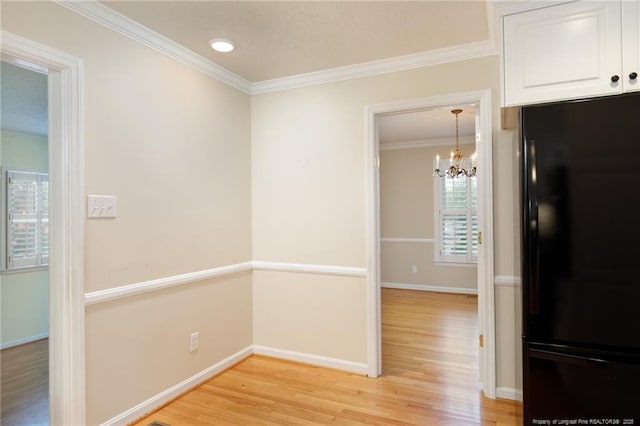 2630 Dartmouth Dr, Fayetteville, NC 28304 - hall featuring light wood-type flooring, a chandelier, and crown molding