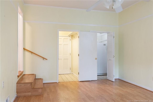 2630 Dartmouth Dr, Fayetteville, NC 28304 - empty room featuring wood finished floors, a ceiling fan, crown molding, and stairs