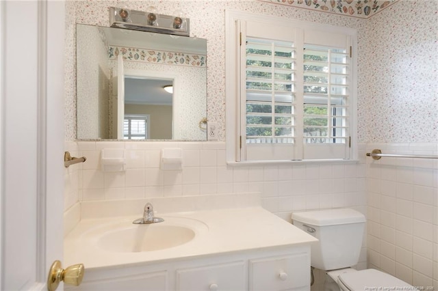2630 Dartmouth Dr, Fayetteville, NC 28304 - half bathroom with wallpapered walls, tile walls, vanity, and a wainscoted wall