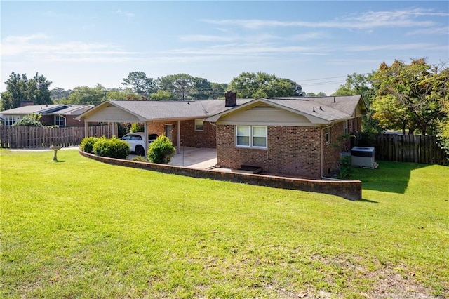 2630 Dartmouth Dr, Fayetteville, NC 28304 - back of property with an attached carport, brick siding, and a chimney
