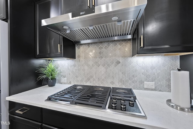 7741 Wilderness Rd, Raleigh, NC 27613 - kitchen featuring extractor fan, dark cabinets, stainless steel gas stovetop, and backsplash